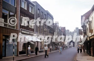 St Peter’s Street in Canterbury in the 1950s looking towards Westgate, with shops including Worlds Stores and Prudential Assurance