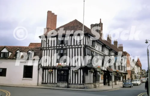 The Falcon Hotel, Stratford-upon-Avon, 1968, timber-framed hotel building on a town street with passing cars.