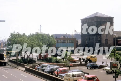 The Strand, Liverpool in 1967 with parked cars, traffic, and surviving brick dockside building on the right.
