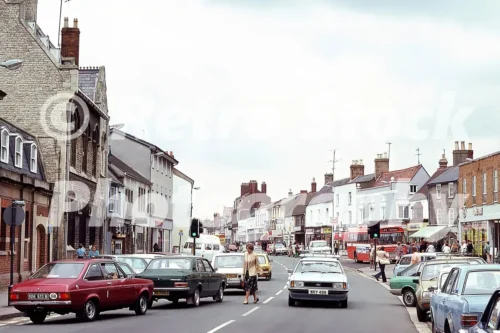 Sheep Street in Bicester with shops, traffic and pedestrians, 1970s
