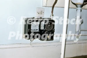 Coin-operated hot water meter in a hotel bathroom, 1970s