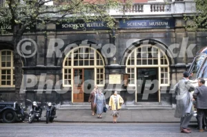 A 1950s colour photo of the entrance to the Science Museum and the School of Textiles in South Kensington, London.