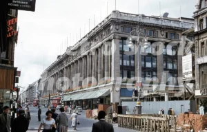 A 1950s colour photo of Selfridges department store on Oxford Street in 1958, showing construction of a new building on the right by Edward Erdman contractors.