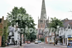 A 1978 photograph of the High Street in Solihull, West Midlands, featuring the historic timber-framed George Hotel, the stone spire of St Alphege Church, and period cars