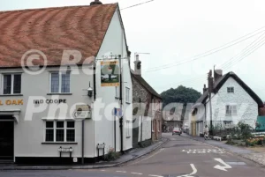A 1978 photograph of The Royal Oak pub in Watlington, Oxfordshire, featuring the white corner building with an Ind Coope hanging sign, situated at the junction of Gorwell and Church Street.