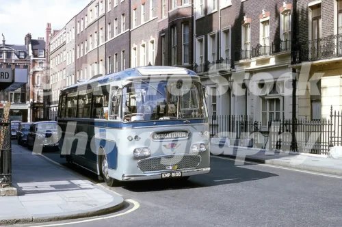 A 1960s colour photo of an American Express coach on Welbeck Street in London, featuring the corner of Bulstrode Street in 1965.