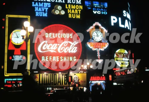 A 1960s colour photo of the glowing neon signs at Piccadilly Circus at night featuring the Bulova Accutron and Coca-Cola displays in 1966.