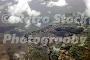 A 1955 aerial photograph of Penarth and the Cardiff coastline, showing the town's residential grid, the Victorian pier, and the winding River Ely meeting the Bristol Channel.