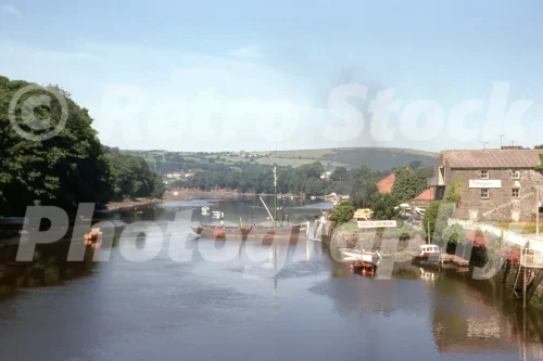 1970s view of Cambrian Quay in Cardigan Wales from Castle Street with boats, quay buildings and the River Teifi