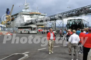 A 1990s view of Fishguard Harbour featuring a white Horseman coach on a DAF SB chassis, passengers in brightly coloured clothing, and a large Stena Sealink ferry.
