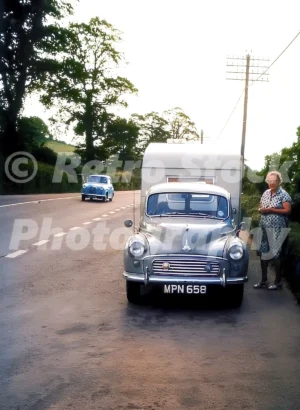 Morris Minor towing a caravan 1960s
