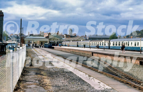 Vintage 1970s colour photo of Aberystwyth station showing the empty Vale of Rheidol Railway platforms with a standard gauge train on the right.