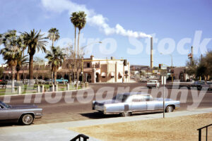 1970s street scene in Ajo, Arizona with a Cadillac Fleetwood and smelter chimney