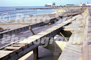 1960s storm damage to the Atlantic City Boardwalk with torn wooden planks