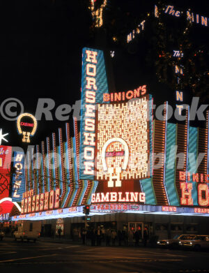 A 1960s colour photo of the glowing neon facade of Binion's Horseshoe Casino on Fremont Street at night in 1968.