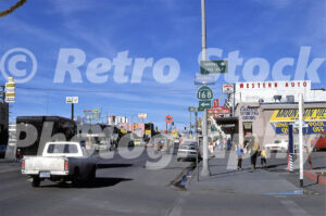 A 1980s color photo of Main Street in Bishop, California, featuring Western Auto, Culver's Sporting Goods, and signage for California Highway 168.
