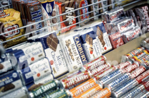 A 1960s color photo of a well-stocked candy counter featuring Cadbury, Life Savers, and Mars bars in Detroit in the 1960s.