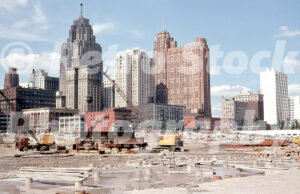 A 1950s color photo of construction cranes and site preparation for Cobo Hall with the Detroit skyline in the background in the late 1950s.
