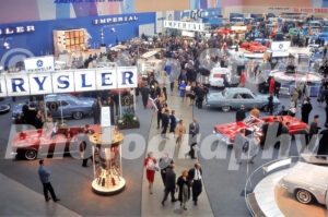 A 1960s color photo of the Chrysler and Imperial showroom display with attendees and new convertibles at the Detroit Auto Show in 1962.