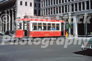 A 1970s color photo of the red and white vintage car no. 4 of the Detroit Citizens Railway on a city street in 1978.
