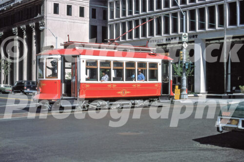A 1970s color photo of the red and white vintage car no. 4 of the Detroit Citizens Railway on a city street in 1978.