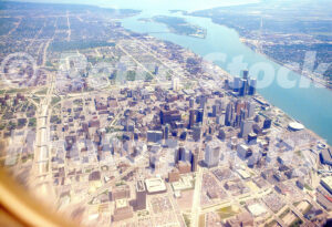 A 1980s color photo of a high-altitude aerial view of downtown Detroit and the Detroit River featuring the Renaissance Center in 1983.
