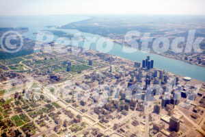 A 1980s color photo of a wide aerial view of the Detroit skyline, the Detroit River, and Belle Isle in 1983.