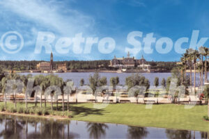 A 1980s color photo of the World Showcase at Epcot Center in Florida, featuring the Italy pavilion campanile and the American Adventure colonial building across the lagoon.