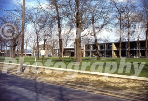 A 1960s color photo of the Flint Institute of Arts and the geodesic dome of the Longway Planetarium in Michigan, featuring mid-century modern campus architecture and autumn trees.