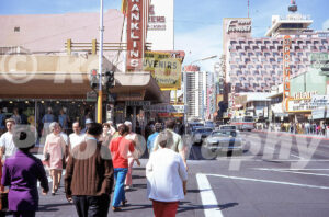 A 1970s color photo of a crowded sidewalk on Fremont Street in Las Vegas with the El Portal Theatre advertising Dirty Harry in 1972.