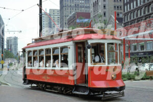 A 1970s color photo of a red and white vintage trolley car #5 operating on the Detroit Citizens Railway in 1977.