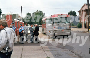 A 1980s colour photo of a silver and red bus with "MEMORIAL" on the front parked outside the Holy Cross Hungarian Church in 1987.