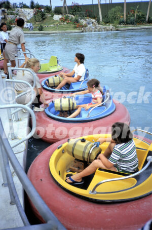 A 1980s color photo of children operating circular bumper boats at Jungleland in North Carolina, with a mini-golf course and a small elephant statue visible in the background.