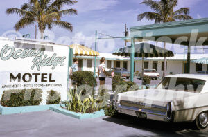 A 1960s colour photo of the Ocean Ridge Motel on Adams Road in Delray Beach, Florida, featuring a large white sign, striped patio umbrellas, and a cream-coloured 1964 Pontiac Star Chief parked in the foreground.
