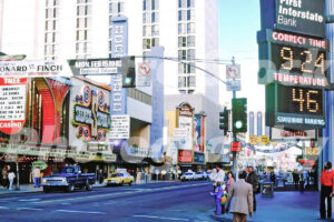 A 1980s color photo of the intersection of Virginia Street and Douglas Alley in Reno featuring the Horseshoe Casino and Sahara Hotel in 1980s.