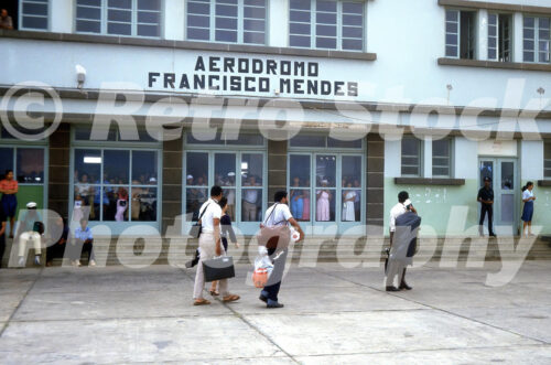 Vintage colour photo of passengers outside Francisco Mendes Airport terminal in Cape Verde during the 1970s.