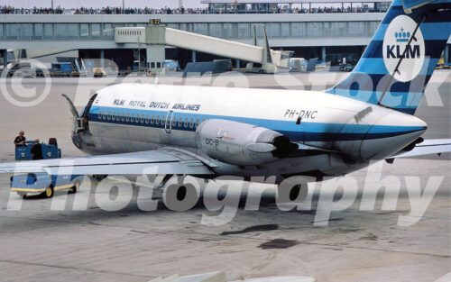x A 1970s colour photo of a KLM Douglas DC-9 PH-DNC at Amsterdam Schiphol Airport in 1970 with the terminal and observation deck in the background.