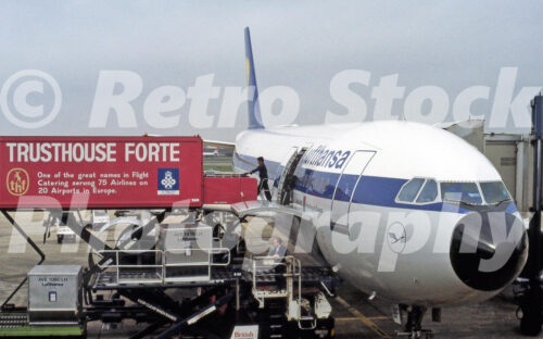 A 1990s colour photo of a Lufthansa Airbus A300 named Kronberg im Taurus being serviced by a Trusthouse Forte catering truck at Heathrow Airport in 1991.