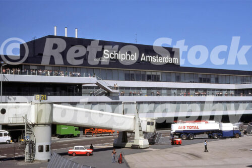 x A 1970s colour photo of the Schiphol Amsterdam Airport terminal building in 1977 with spectators on the observation deck and an Air Total tanker.