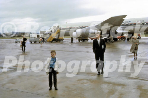 A 1960s colour photo of a SAS Douglas DC-8-55 named Folke Viking on the tarmac in 1965 with passengers deplaning.