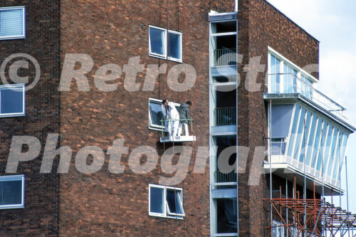 Men working on the exterior of Heathrow Airport control tower in the 1980s