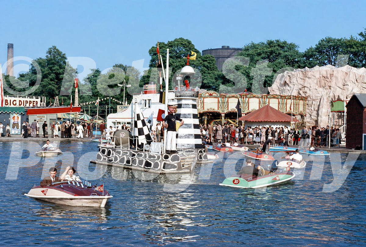 Vintage 1950s colour photo of the boating lake at the Festival Pleasure Gardens in Battersea Park, London, with small motor boats and crowds.