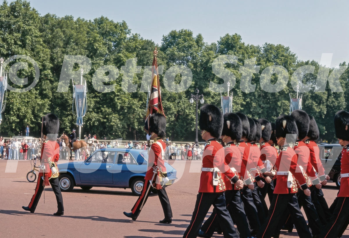 A 1970s colour photo of Foot Guards marching past a blue Austin Allegro outside Buckingham Palace in 1977 during the Silver Jubilee celebrations.