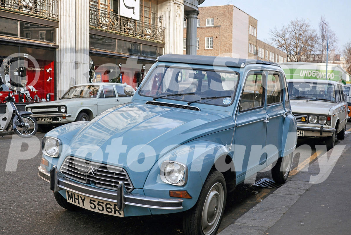 citroen-dyane-london-1976_55231743396_o 1970s London street view with a pale blue Citroën Dyane parked at the kerb outside shops.
