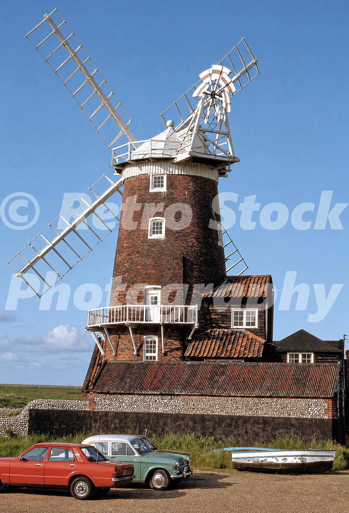 cley-windmill-cley-next-the-sea-norfolk-1970s_55231895598_o 1970s photo of Cley Windmill at Cley-next-the-Sea, Norfolk, with a red Ford Cortina and a green Hillman Minx parked in front.