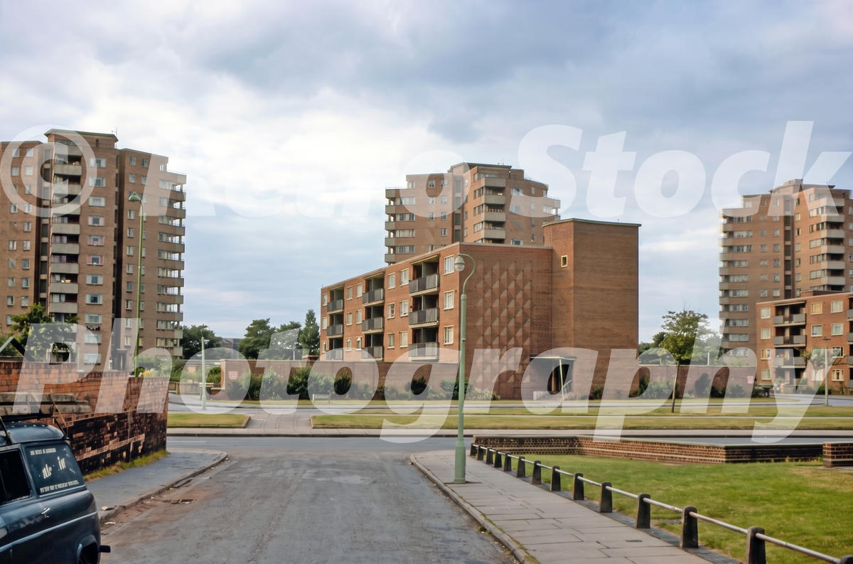 1960s view of High Tower, Queen’s Tower and Home Tower on Duddeston Manor Road in Birmingham, with brick flats, grassed areas and modern street lighting.