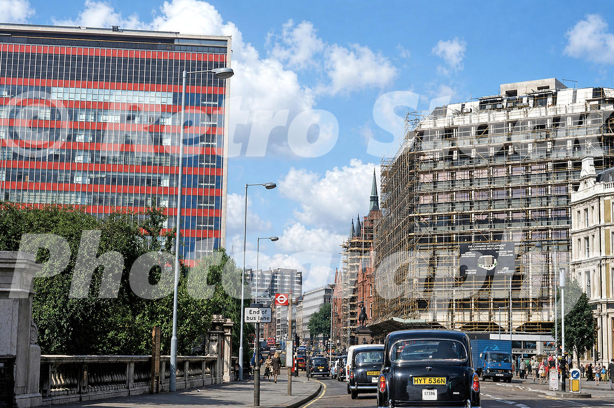 old photo of Holborn Viaduct in London in the 1970s looking towards Holborn Circus with the Daily Mirror building, scaffolding on the former Gamages site and busy traffic below