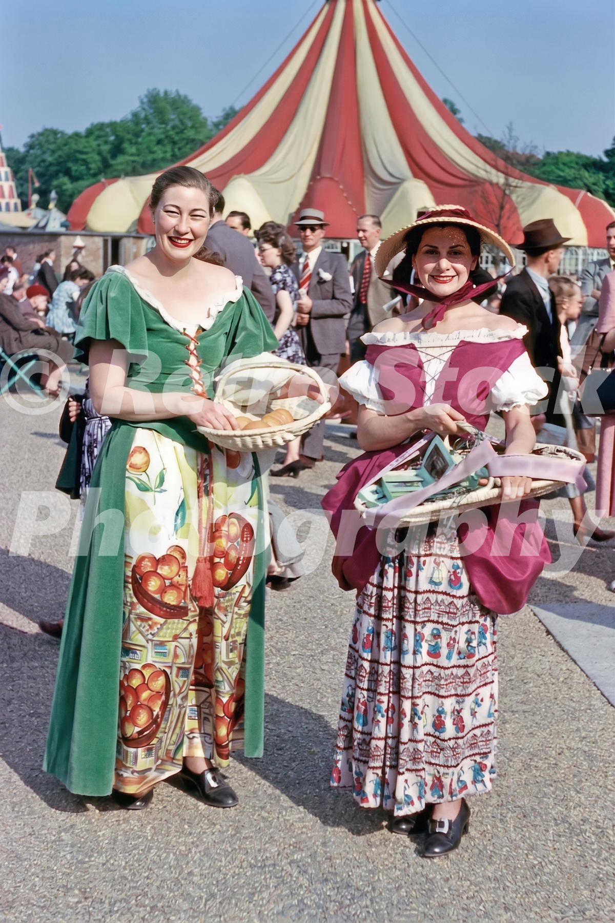 1950s colour photo of two women selling oranges and lavender at the Festival of Britain in Battersea Park.