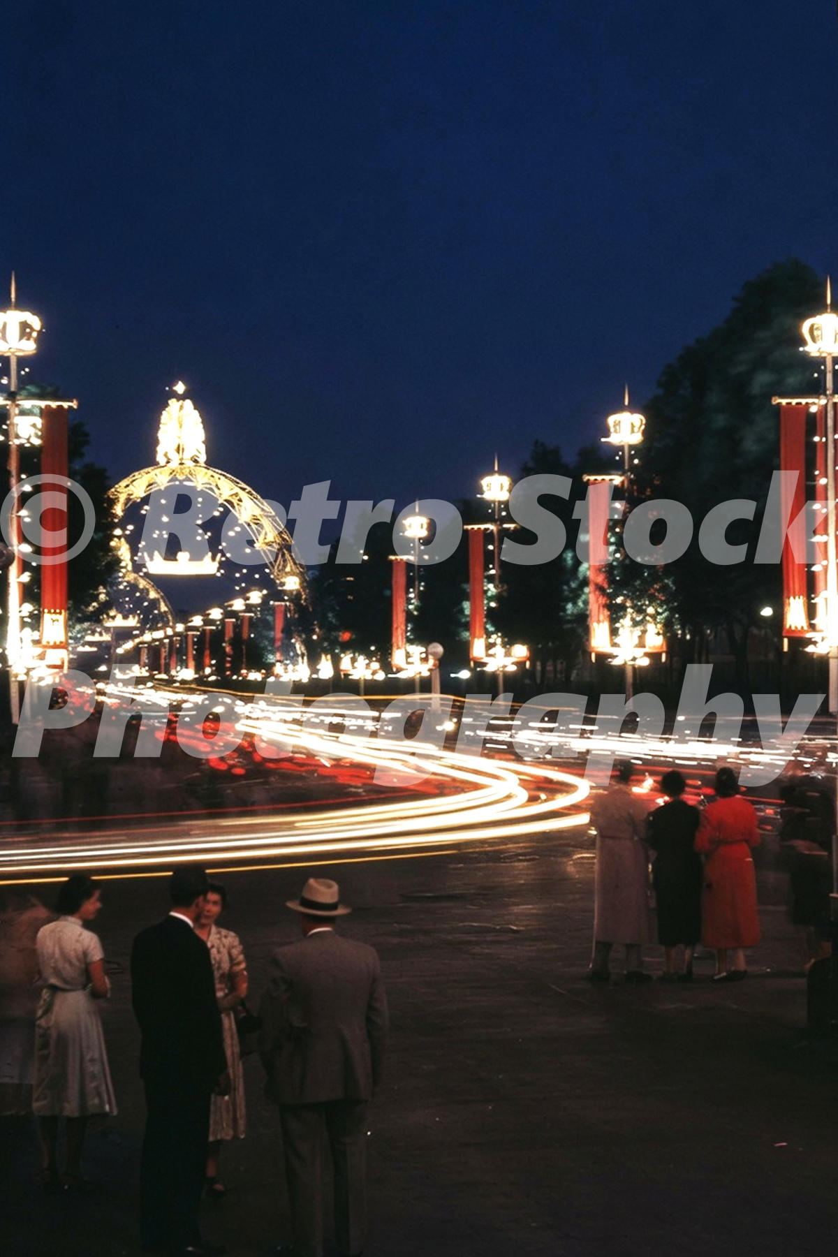 1953 night view of The Mall in London decorated with lights and crowns for Queen Elizabeth II’s coronation.