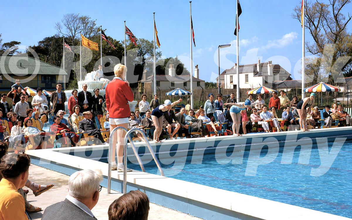 Redcoat leading an outdoor pool event at Butlins Bognor Regis with swimmers, spectators and fountain, 1960s